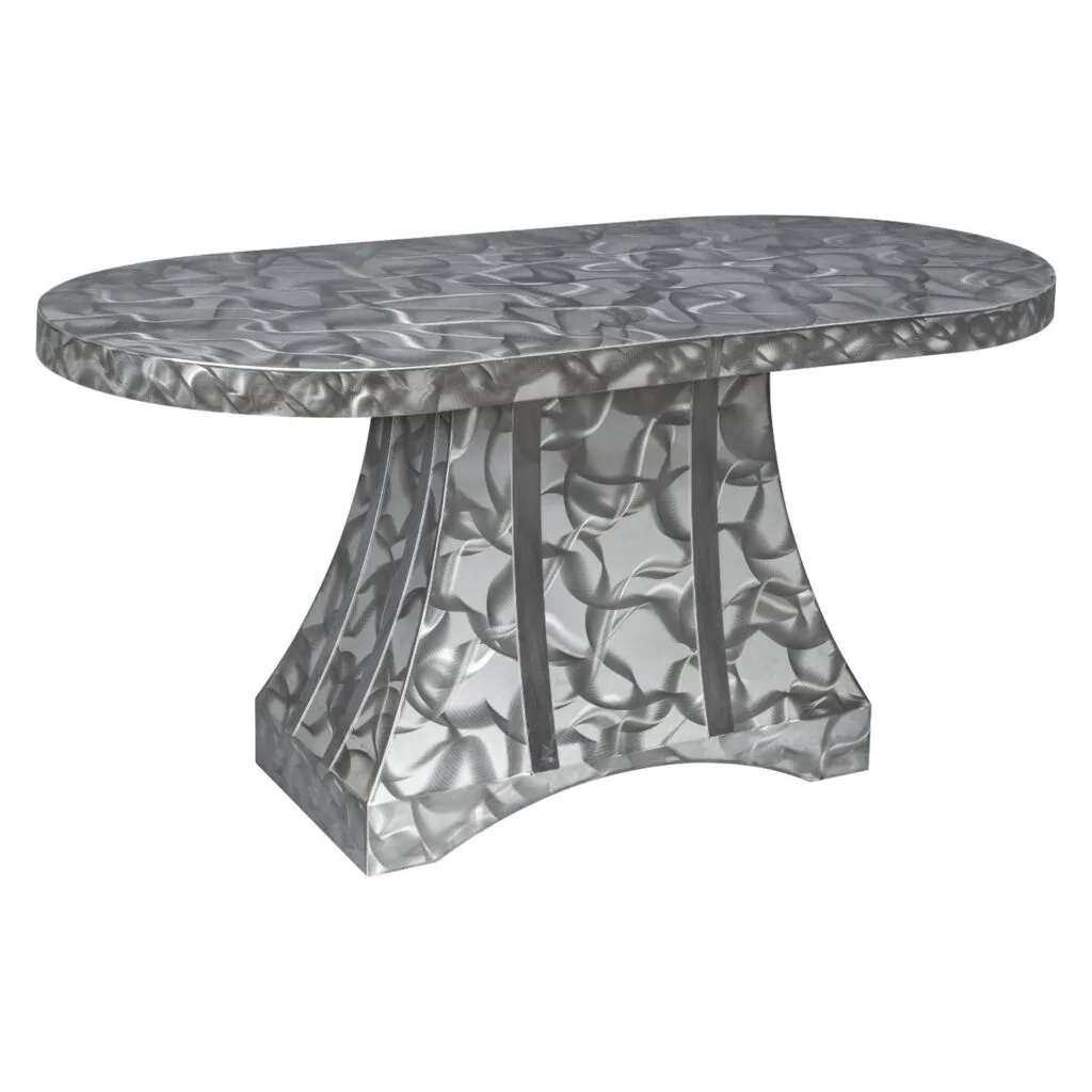 Oval dining table with brushed stainless steel top and sculpted pedestal base from Rocket Outdoors, on a white studio background.