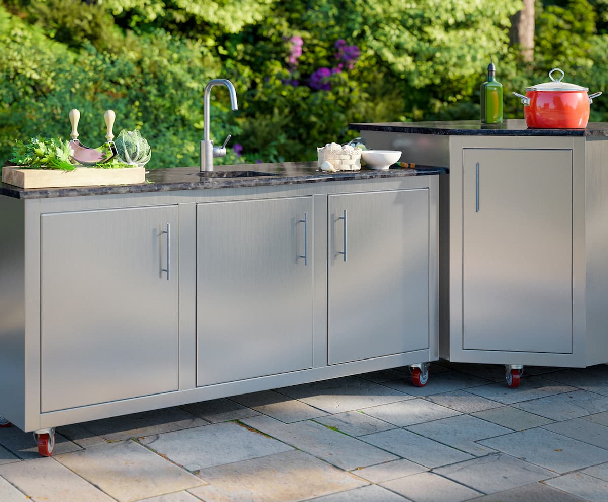 Rocket Outdoors stainless steel outdoor kitchen cabinets on casters with a sink, prep counter, and storage drawers on a backyard patio.