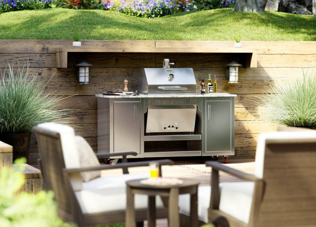 Silver Rocket grill cabinet built into a timber retaining wall with lantern sconces and outdoor lounge seating in the foreground.