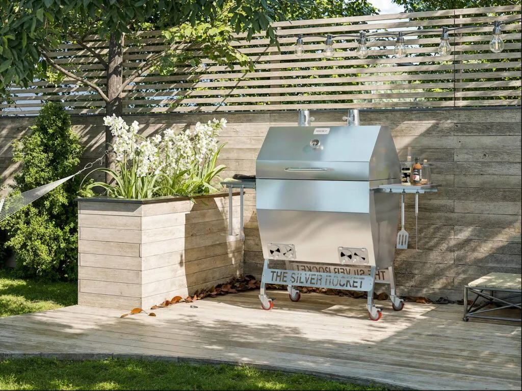 Silver Rocket Large Smoker on Backyard Deck by Planter