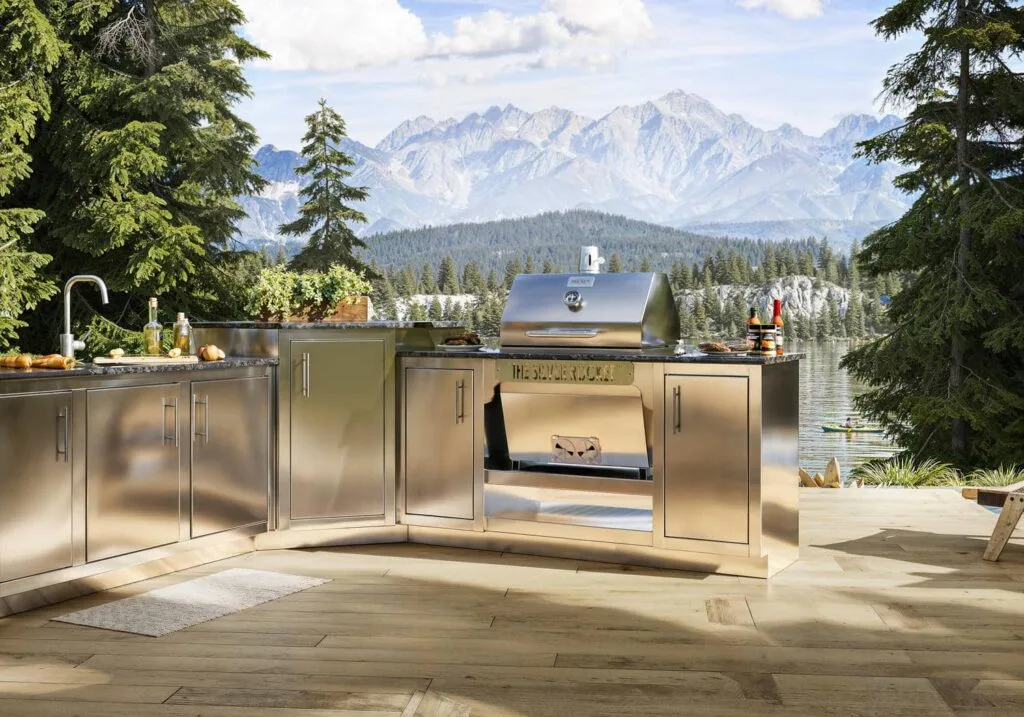 Stainless steel Silver Rocket outdoor kitchen with built-in grill, sink, and prep stations overlooking a mountain lake.
