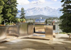 Stainless steel Silver Rocket outdoor kitchen with built-in grill, sink, and prep stations overlooking a mountain lake.